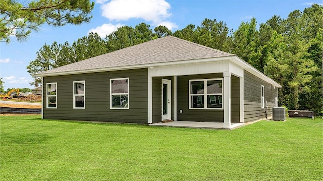 114 Kieran Trce, Dothan, AL 36301 - back of house featuring a shingled roof, central AC, a lawn, and a patio