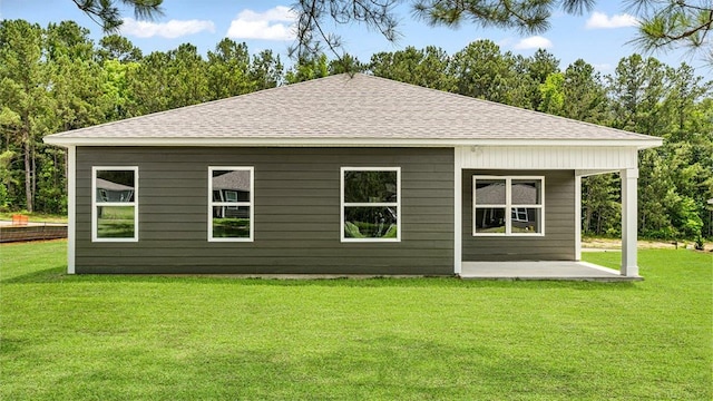 114 Kieran Trce, Dothan, AL 36301 - back of house featuring roof with shingles, a patio area, and a lawn