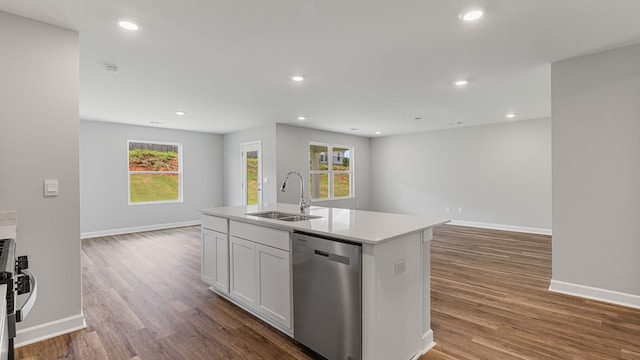 kitchen with a sink, open floor plan, stainless steel dishwasher, and recessed lighting