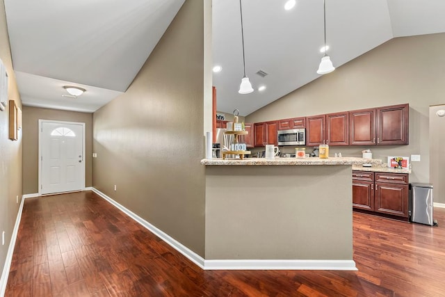 kitchen featuring stainless steel microwave, baseboards, dark wood-style floors, and visible vents