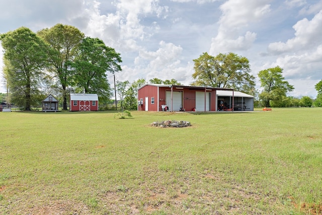 view of yard with an outbuilding, an outdoor structure, and a detached garage