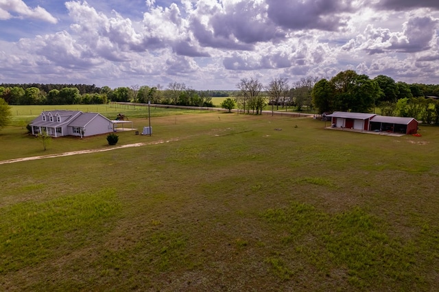 view of yard with a rural view and an outbuilding