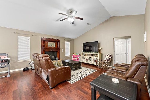 living room with visible vents, baseboards, a ceiling fan, wood finished floors, and lofted ceiling