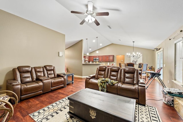 living room with visible vents, ceiling fan with notable chandelier, wood finished floors, and lofted ceiling