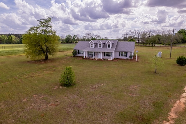 view of front of home featuring a porch, a rural view, and a front yard