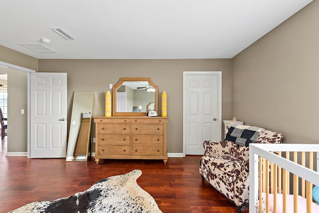 bedroom with dark wood-type flooring, visible vents, and baseboards