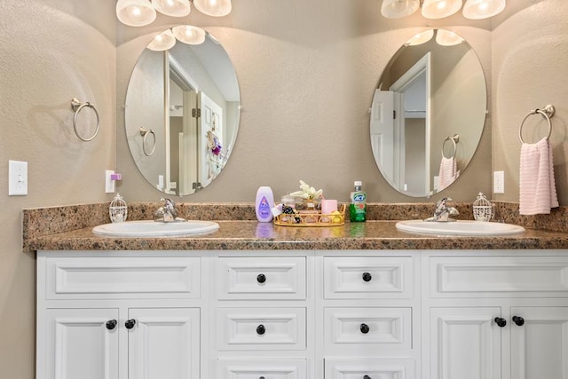 bathroom with a sink and double vanity