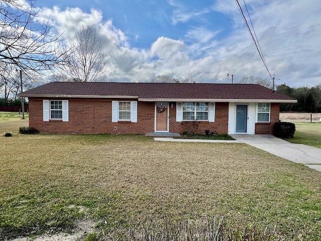 ranch-style home with a front lawn, concrete driveway, and brick siding