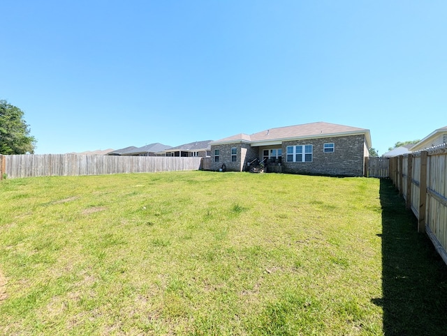 view of yard with a fenced backyard