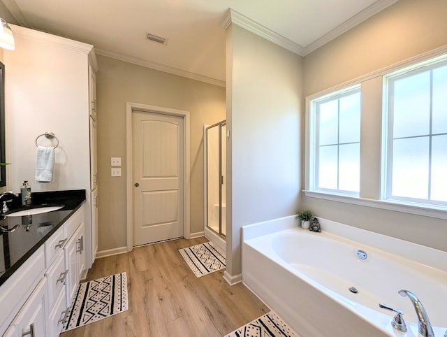 full bathroom featuring visible vents, wood finished floors, a shower stall, and a garden tub