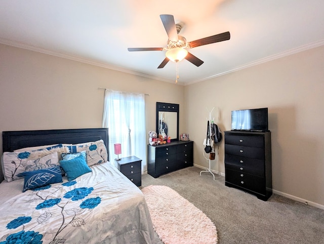 carpeted bedroom with crown molding, a ceiling fan, and baseboards