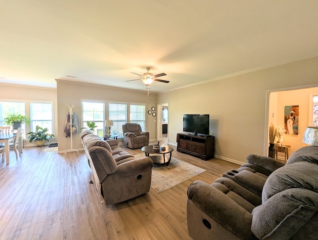 living room with wood finished floors, crown molding, a ceiling fan, and baseboards