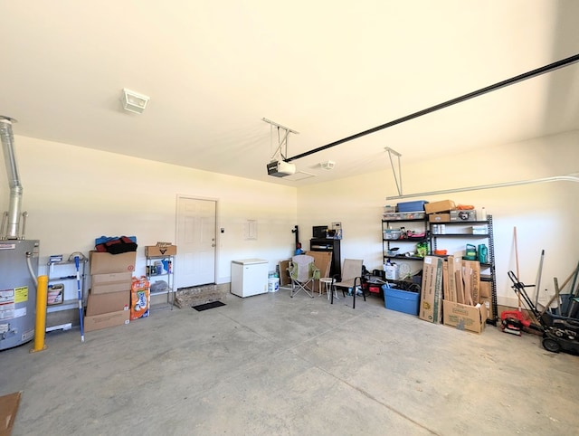 garage with a garage door opener and electric water heater