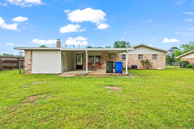 702 Highland St, Dothan, AL 36301 - rear view of property with a chimney, a patio area, and brick siding