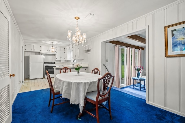 702 Highland St, Dothan, AL 36301 - dining area with a chandelier, dark carpet, a decorative wall, and ornamental molding