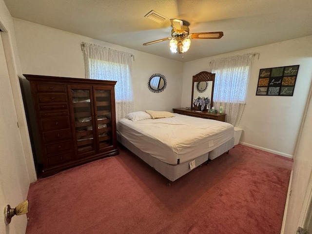 carpeted bedroom featuring a ceiling fan and baseboards