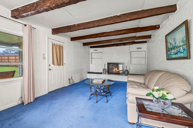 702 Highland St, Dothan, AL 36301 - living room with carpet, a glass covered fireplace, and beamed ceiling