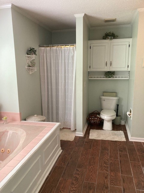 bathroom featuring crown molding, a shower with shower curtain, a textured ceiling, and toilet