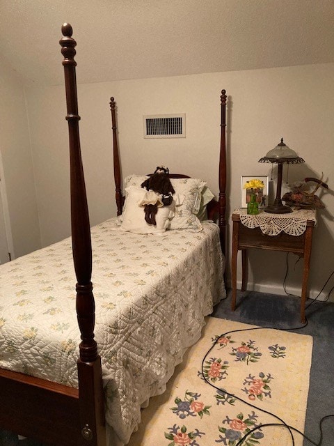bedroom with baseboards and visible vents