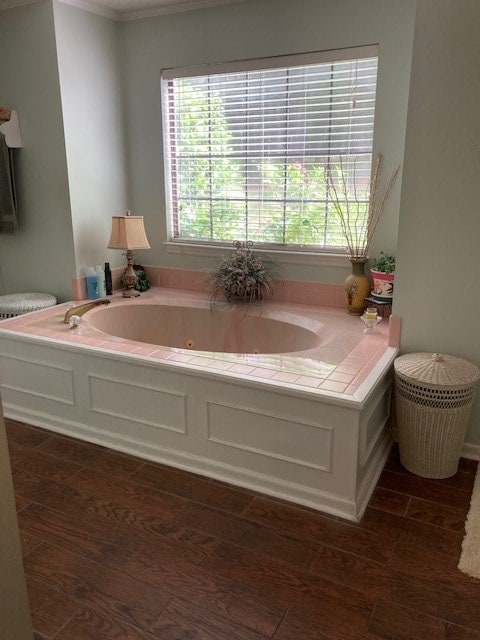 full bath featuring a tub with jets and wood finished floors