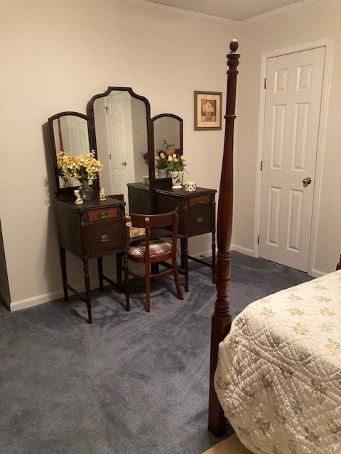 bedroom featuring crown molding and dark colored carpet