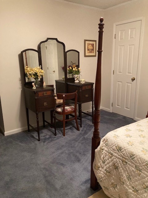 bedroom with baseboards and dark colored carpet