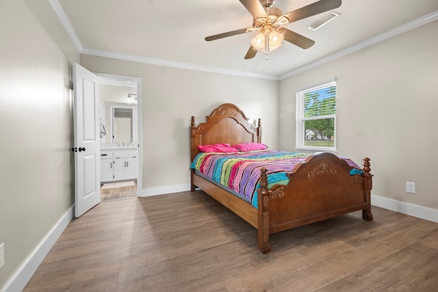 bedroom featuring baseboards, crown molding, wood finished floors, and visible vents