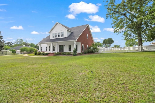 view of front of home featuring a front yard and fence