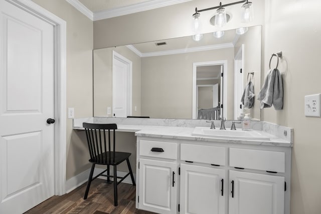 bathroom with ornamental molding, vanity, wood finished floors, and visible vents