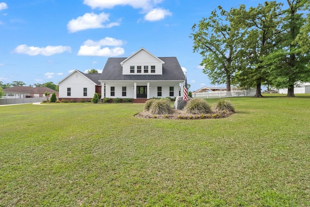 view of front of house with fence, a porch, and a front yard
