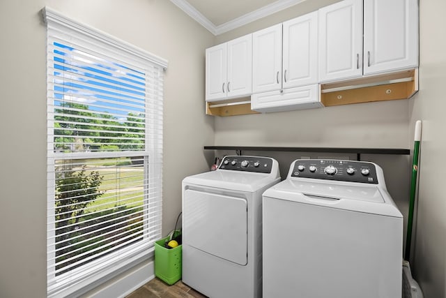 washroom featuring dark wood finished floors, washer and dryer, cabinet space, and crown molding
