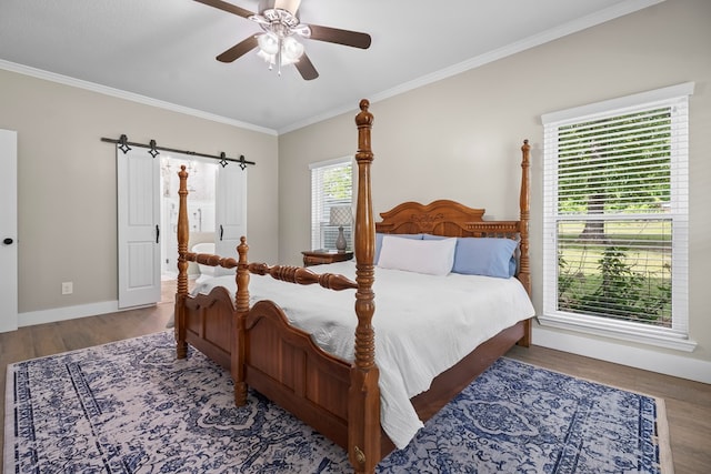 bedroom with baseboards, wood finished floors, ceiling fan, and crown molding
