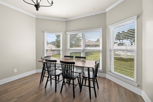 dining area with wood finished floors, baseboards, and ornamental molding