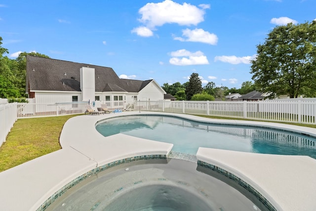 view of pool with a lawn, a fenced backyard, a pool with connected hot tub, and a patio