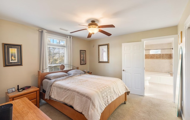 carpeted bedroom featuring connected bathroom and ceiling fan