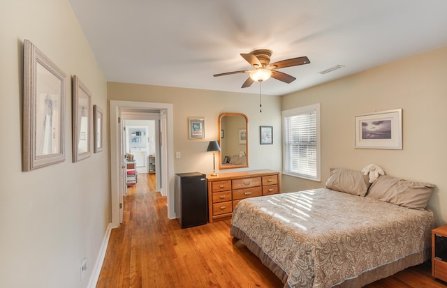 bedroom with light hardwood / wood-style floors and ceiling fan