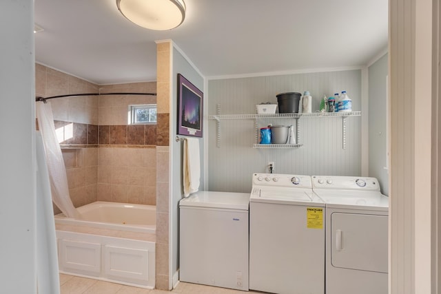 laundry area with washing machine and dryer, light tile patterned flooring, and ornamental molding