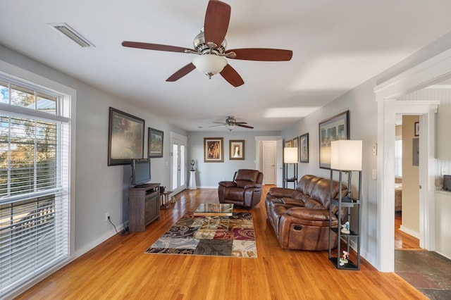 living room featuring ceiling fan and light wood-type flooring