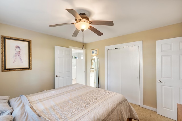 bedroom featuring ceiling fan, light carpet, and a closet