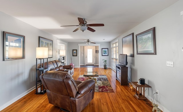 living room with hardwood / wood-style floors and ceiling fan