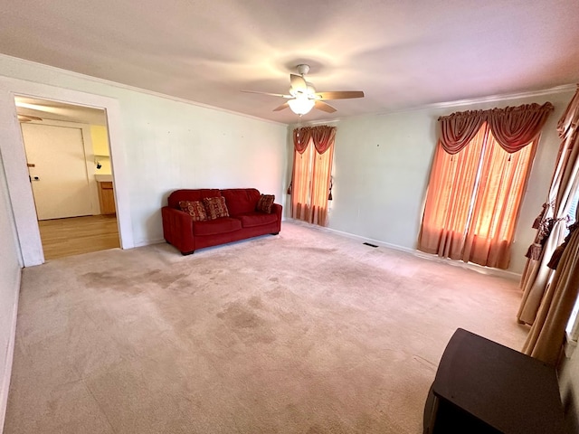 unfurnished room with ceiling fan, carpet, visible vents, and ornamental molding