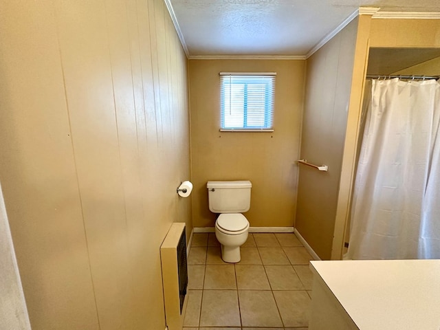 bathroom featuring tile patterned floors, heating unit, toilet, and crown molding