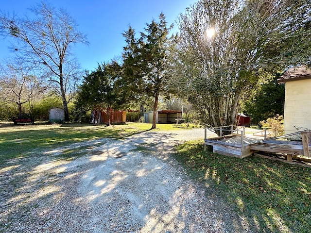 view of yard with an outbuilding and a storage shed