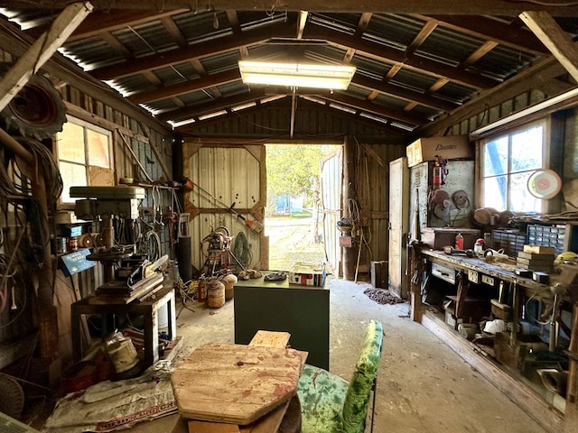 miscellaneous room featuring a workshop area and lofted ceiling