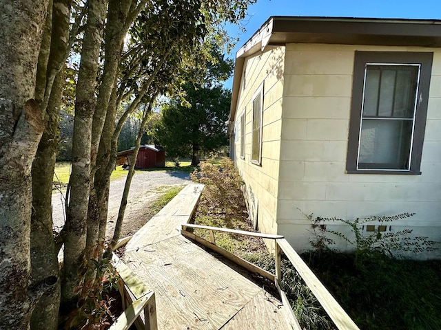 view of property exterior with concrete block siding and an outdoor structure