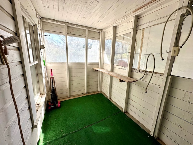 unfurnished sunroom with wood ceiling