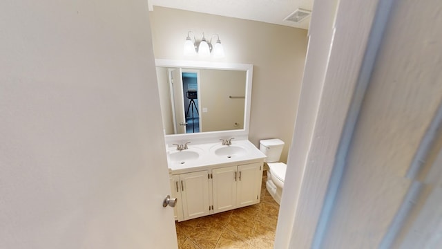 bathroom with tile patterned flooring, vanity, and toilet