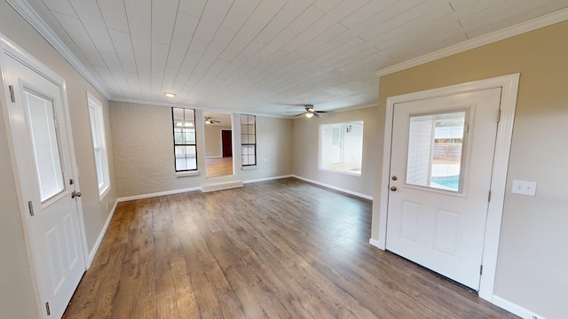 interior space with ceiling fan, wood-type flooring, crown molding, and wooden ceiling