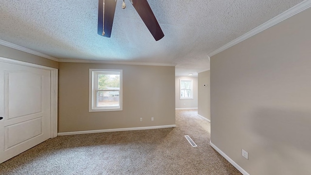 carpeted empty room featuring a textured ceiling, ceiling fan, and ornamental molding