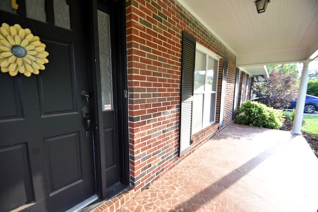 208 Pinehurst Dr, Enterprise, AL 36330 - doorway to property with covered porch and brick siding